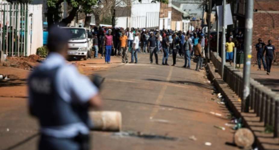 Gangs of aggressors armed with sticks and machetes attacked businesses in South Africa's financial capital last month during deadly xenophobic attacks.  By GUILLEM SARTORIO AFP