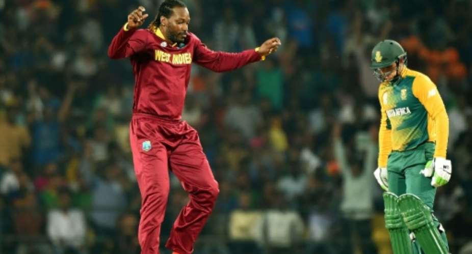 West Indies' Chris Gayle L celebrates after taking the wicket of South Africa's Rilee Rossouw during the World T20 match at The Vidarbha Cricket Association Stadium in Nagpur on March 25, 2016.  By Punit Paranjpe AFP