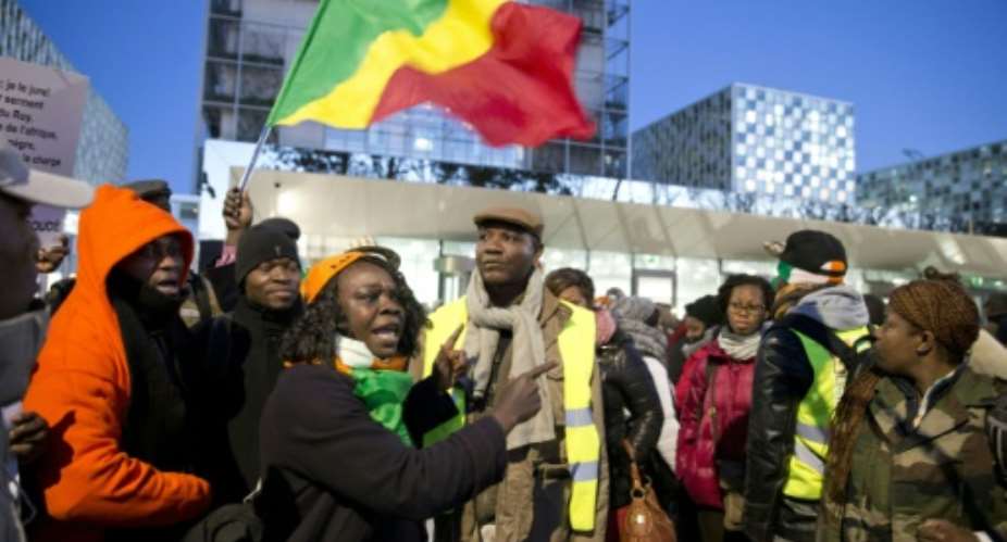 Supporters of former Ivory Coast president Laurent Gbagbo and former minister Charles Ble Goude rally outside the International Criminal Court of The Hague on January 28, 2016.  By Peter Dejong ANPAFP