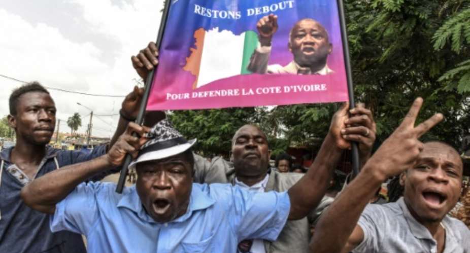 Gbagbo supporters in Abidjan celebrate his acquittal by the ICC in January 2019.  By ISSOUF SANOGO AFP