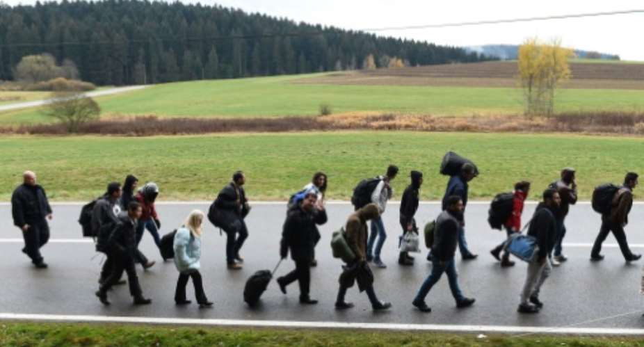 Migrants on the road after crossing the Austrian-German border near the Bavarian village of Wegscheid, southern Germany on November 9, 2015.  By Christof Stache AFPFile
