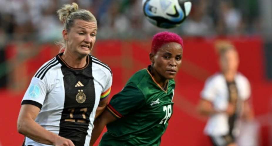 Germany's forward Alexandra Popp L and Zambia's Susan Banda battle for the ball during a recent friendly.  By CHRISTOF STACHE AFP
