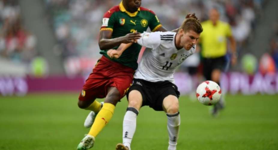 Germany's forward Timo Werner R challenges Cameroon's defender Ernest Mabouka during the 2017 FIFA Confederations Cup group B football match June 25, 2017.  By Yuri CORTEZ AFP