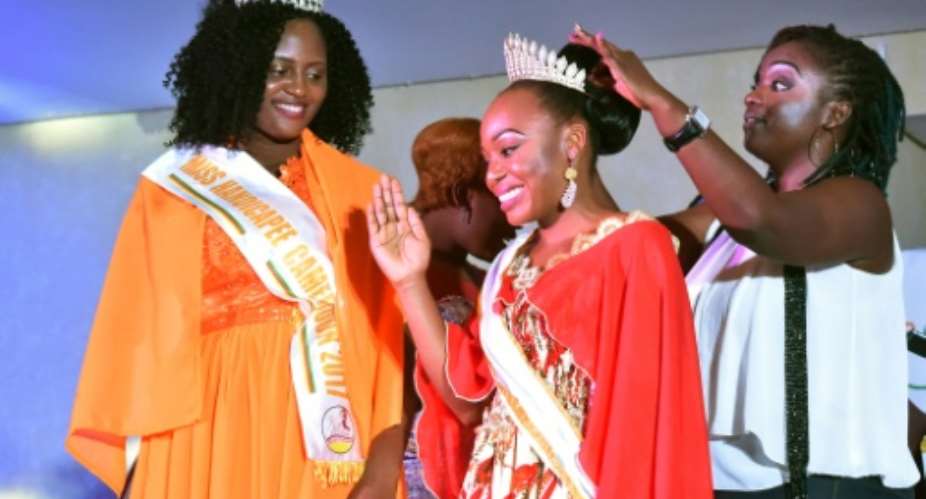 Getheme Lokou, who lost an arm in a childhood accident, was crowned Miss Handicap Ivory Coast 2018 as her Cameroonian counterpart Laura Tchokotcheu -- also an amputee -- looked on.  By SIA KAMBOU AFPFile