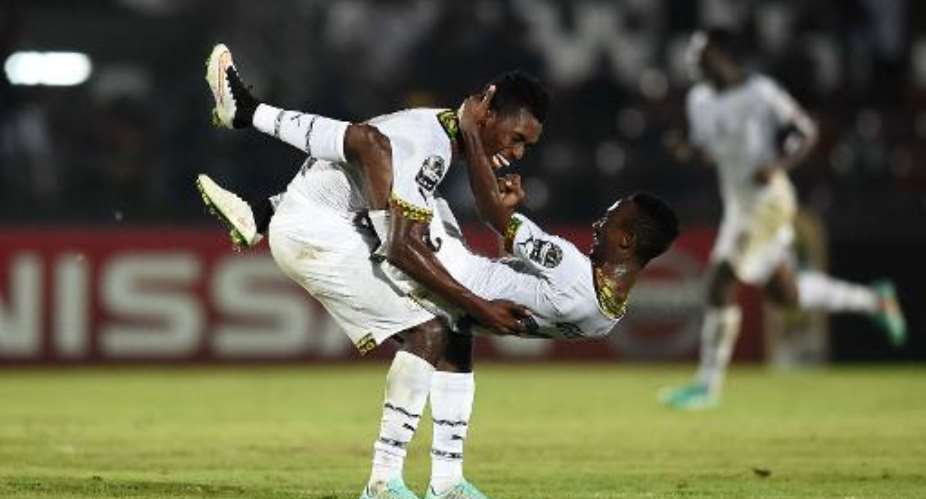 Ghana's defenders John Boye and Harrison Afful R celebrate after winning the 2015 African Cup of Nations group C football match between South Africa and Ghana in Mongomo on January 27, 2015.  By Carl De Souza AFP