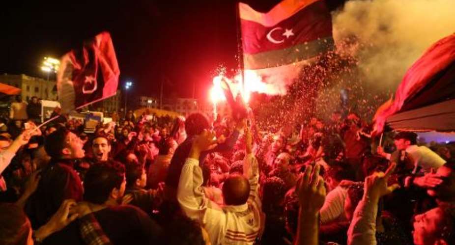 Libyan football fans celebrate in Martyrs' Square in the Libyan capital Tripoli on January 29, 2014 after the national team defeated Zimbabwe in its African Nations Championship semi-final match.  By  AFP