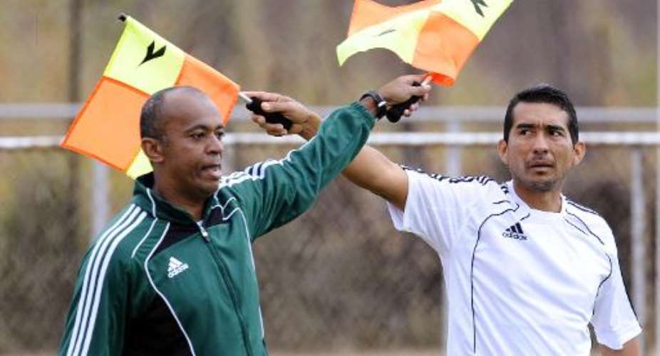 Assistant referees Abraham Gonzalez (left) and Humberto Clavijo at a training session for assistant referees on June 29, 2010 at Kievits Kroon, the referee headquarters in Pretoria for the 2010 World Cup.  By Daniel Garcia (AFP)