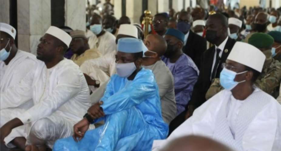 Goita, dressed in blue, at the prayers in Bamako's Grand Mosque shortly before the attack.  By Malick KONATE AFP