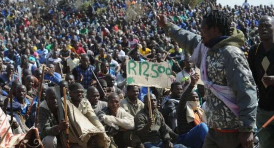 Miners on strike at the platinum mine in Marikana on August 16.  By Stringer (AFP/File)