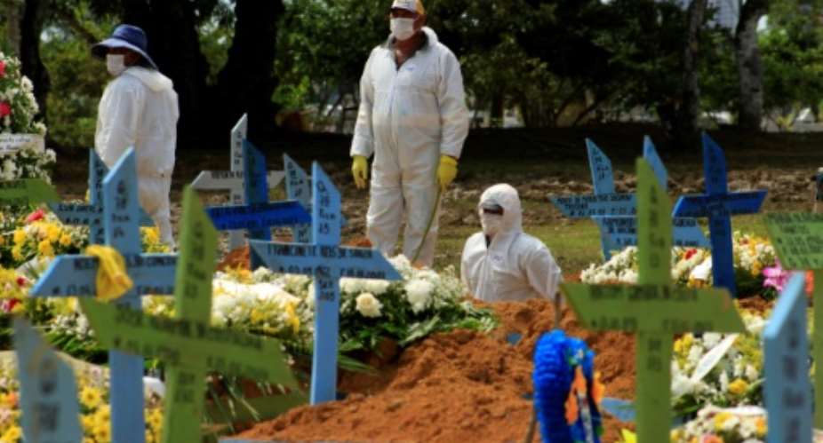 Gravediggers pictured during a funeral of a COVID-19 victim at the Nossa Senhora Aparecida cemetery in Manaus, Amazonas state, Brazil.  By MARCIO JAMES AFPFile