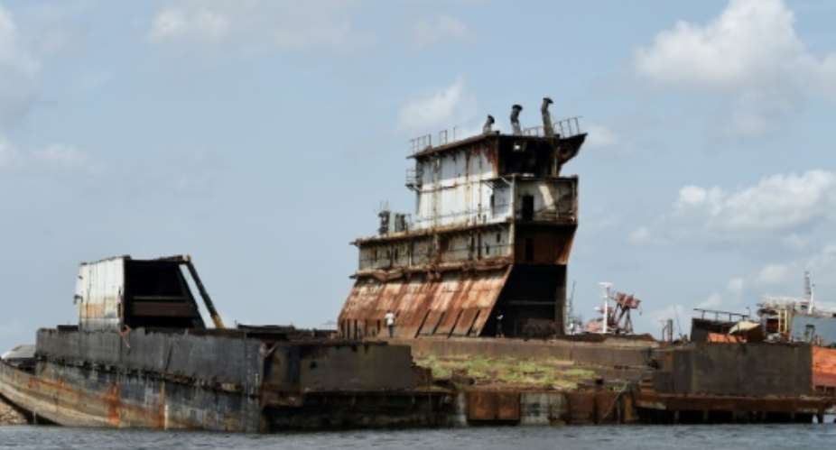 Graveyard: Dozens of shipwrecks and abandoned barges litter the Lagos waterways.  By PIUS UTOMI EKPEI AFP