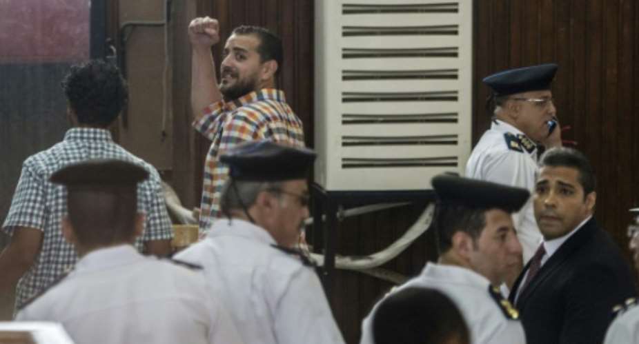 Al-Jazeera journalists, Canadian Mohamed Fahmy R and Egyptian Baher Mohamed C, attend their trial in the capital Cairo on August 29, 2015.  By Khaled Desouki AFP