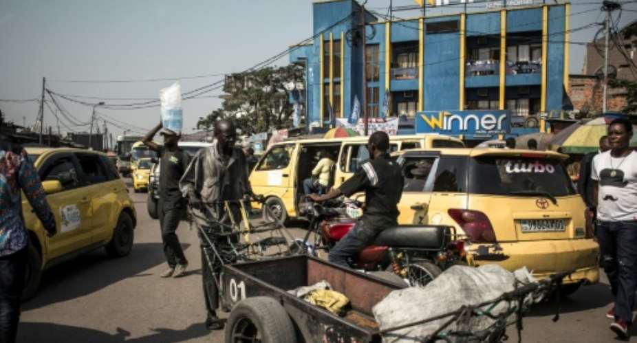 Gridlocked: Yellow taxis clog the streets of Kinshasa.  By John WESSELS AFP