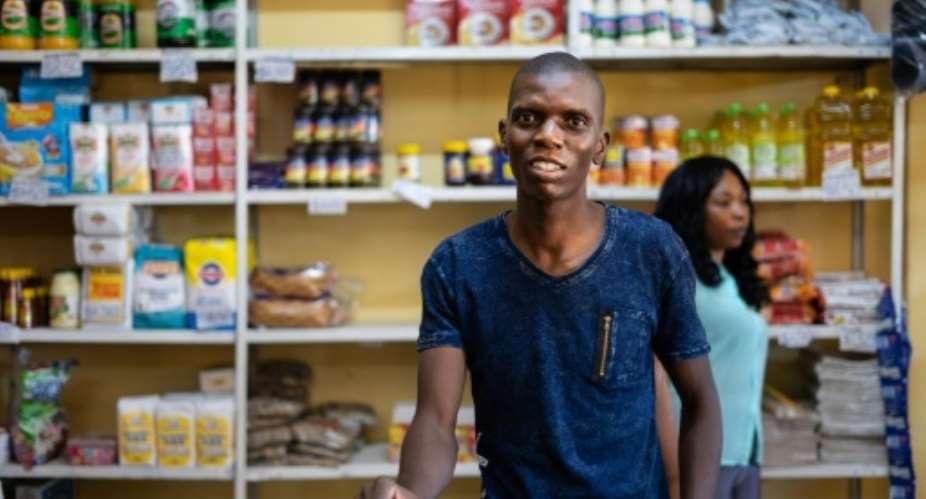 Grocery store owner Blessing Mushonga in his shop in Rimuka township, Kadoma. Life is getting harder for many Zimbabweans as the economic crisis worsens -- daily necessities are often in short supply.  By ZINYANGE AUNTONY AFPFile