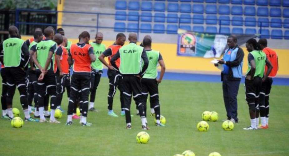 Botswana team coach Stanley Tshosane (3rd R) speaks to players during a training session ahead of match vs Guinea.  By Pius Utomi Ekpei (AFP/File)
