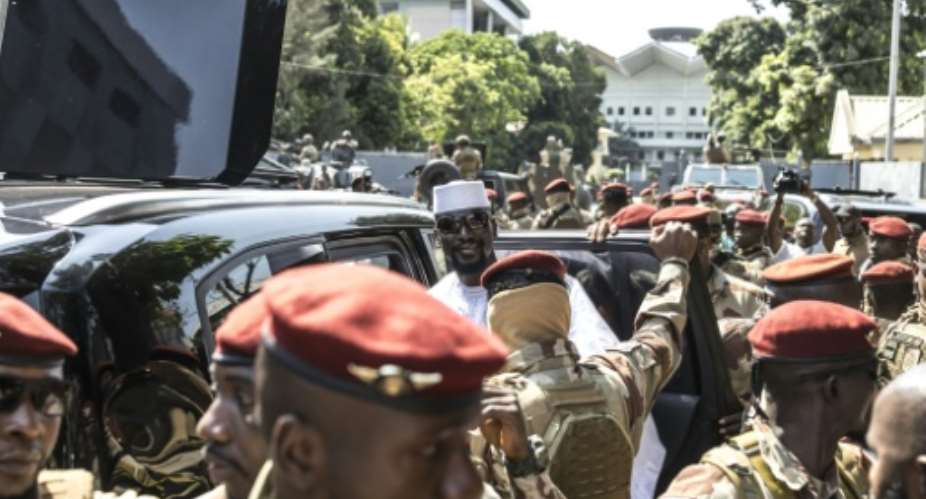 Guinea junta chief and presidential candidate Mamady Doumbouya (CR) seized power four years ago.  By PATRICK MEINHARDT (AFP)