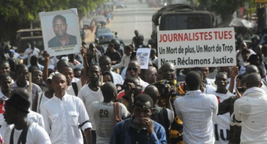 Guinean journalists march on February 8, 2016 in Conakry to protest after a journalist was shot in clashes outside the offices of an opposition party on February 5.  By Cellou Binani AFP