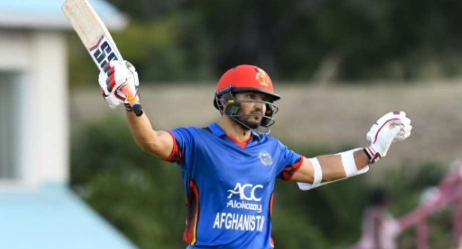 Gulbadin Naib of Afghanistan celebrates his half century during the second ODI against the West Indies at Darren Sammy National Cricket Stadium in Gros Islet, St. Lucia, June 11, 2017.  By Randy BROOKS AFPFile