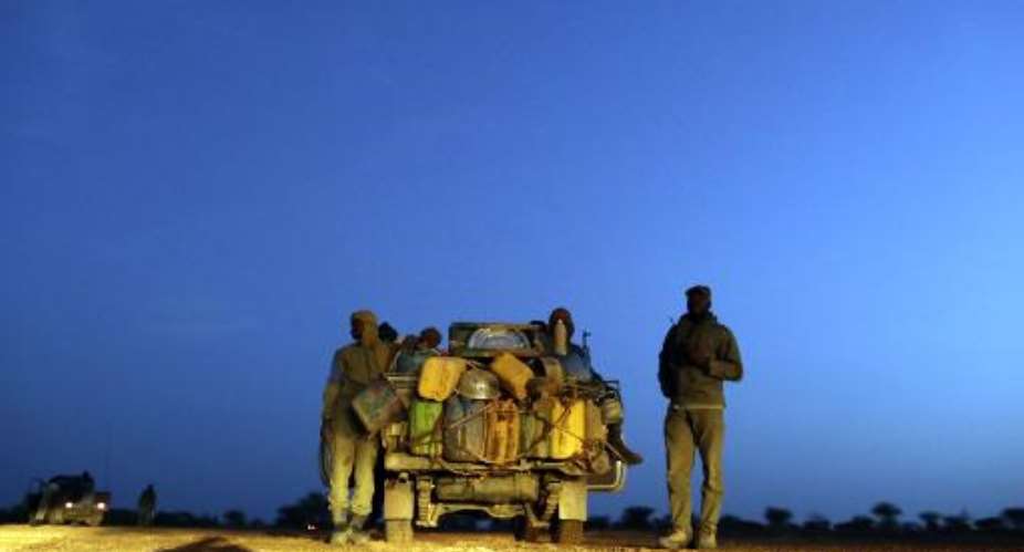 Malian soldiers patrol on a road between Kidal and Gao on July 29, 2013 in northern Mali.  By Kenzo Tribouillard AFPFile