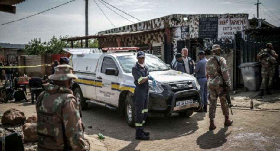Gunmen armed with assault rifles stormed the  bar outside Johannesburg on Saturday evening.  By EMMANUEL CROSET (AFP)