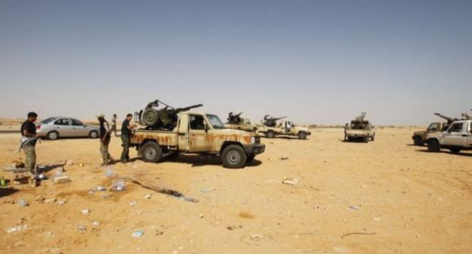 Armed Libyans, who claim to be federalist supporters, set up a checkpoint outside Sidra oil terminal, near Ras Lanuf.  By Mohammed Abed (AFP)