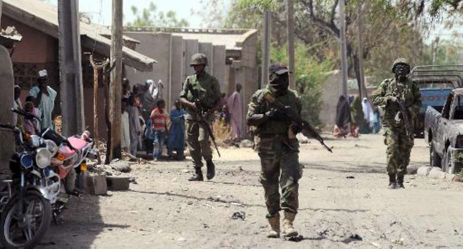 This picture taken on April 30, 2013 shows Nigerian troops patrolling in the streets of the remote northeast town of Baga.  By Pius Utomi Ekpei AFPFile