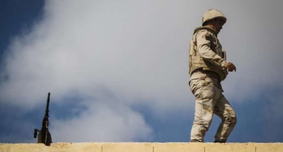 An Egyptian soldier stands guard along the Rafah border with Israel on July 19, 2014.  By Mohamed el-Shahed AFP