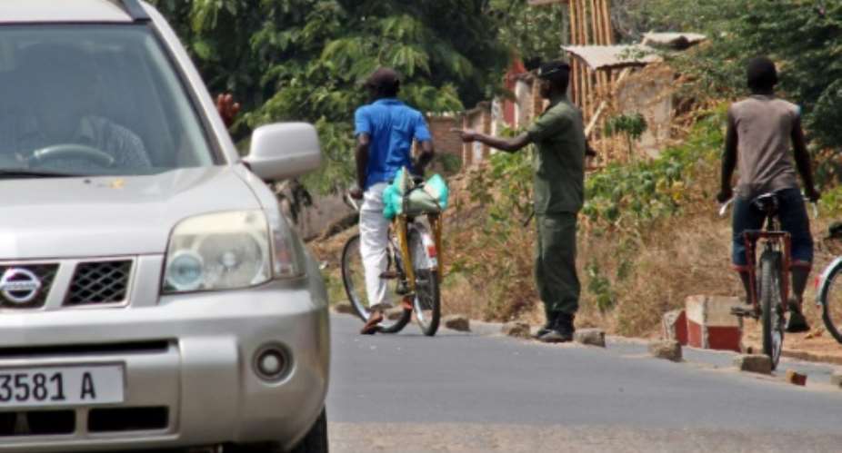 File picture shows a policeman at a road block in the Burundian capital Bujumbura.  By Landry Nshimiye AFPFile