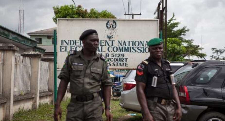 Nigerian police stand guard outside the Independent National Electoral Commission INEC offices in Port Harcourt, on March 26, 2015.  By Florian Plaucheur AFPFile