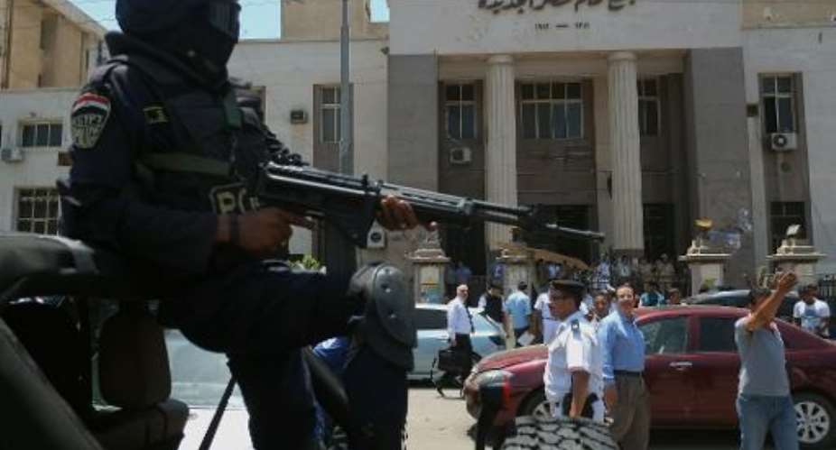 Egyptian police special forces secure the area outside a courthouse in the Cairo district of Heliopolis on June 25, 2014.  By Khaled Desouki AFPFile