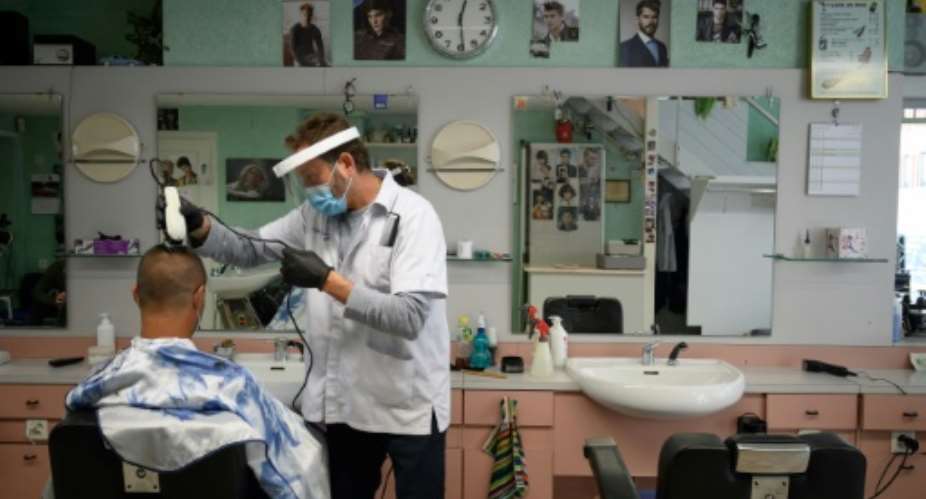 Hairdressers in Switzerland were allowed to reopen, but had to put protective measures in place.  By Fabrice COFFRINI AFP