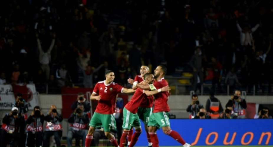 Hakim Ziyech scored twice for Morocco against Cameroon and their qualification for the African Cup of Nations was confirmed when Malawi slipped away to Comoros.  By FADEL SENNA AFP