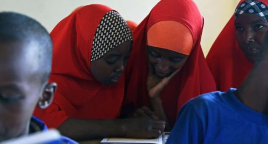 Halima C who was married at the age of 13 to a man 12 years her senior, studies with fellow pupils at a school in Wajir, Kenya.  By Nicolas Delaunay AFP