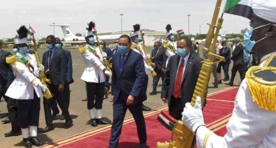 Hamdok centre right welcomes Madbouli centre left in Khartoum. It is Madbouli's first official visit to Sudan since the formation of its transitional government in 2019.  By - Egyptian Prime Minister's OfficeAFP