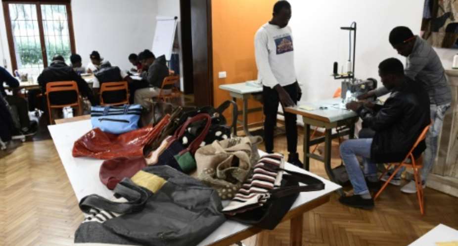 Handbags made by migrants at the Lai-Momo headquarters, a vocational training programme to teach skills in leather bag making to those seeking asylum in Italy..  By MIGUEL MEDINA AFP