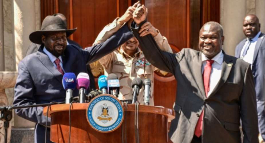 Hands together: South Sudan President Salva Kiir, left, and rebel leader Riek Machar in Juba on December 17 last year.  By Majak Kuany, Majak Kuany AFPFile