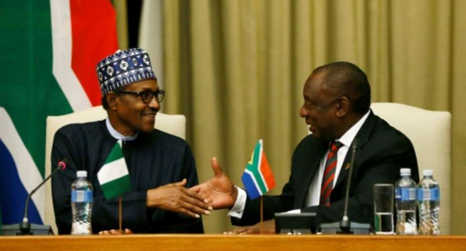 Handshake: Buhari, left, and Ramaphosa.  By Phill Magakoe AFP
