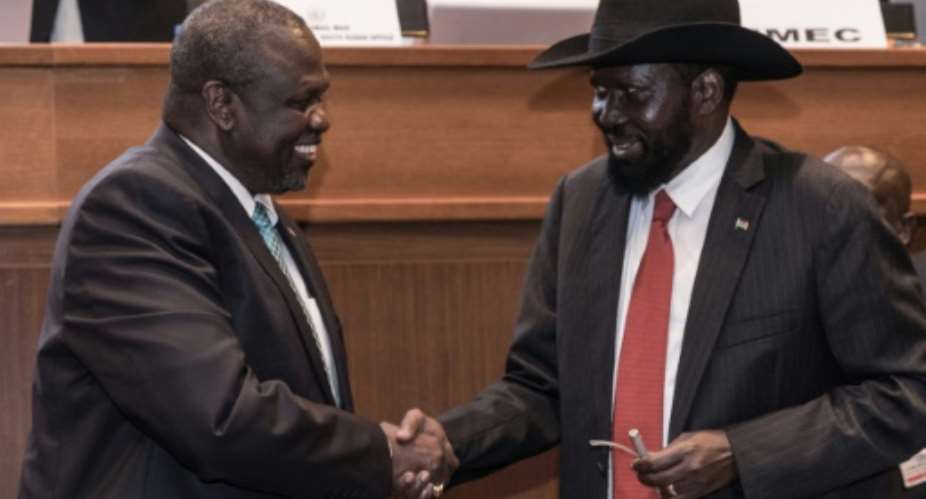 Handshake: South Sudan's president, Salva Kiir, right, and his former deputy turned rebel leader, Riek Machar, seal the peace deal in Addis Ababa last September.  By YONAS TADESSE AFP