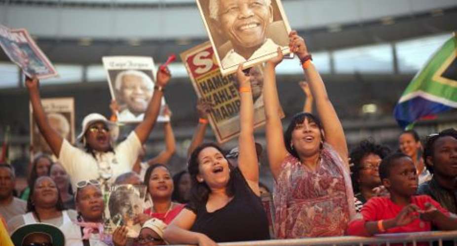 People enjoy the Nelson Mandela tribute concert, called,  A life celebrated, at Cape Town Stadium on December 11 2013, in Cape Town, South Africa.  By Rodger Bosch AFP