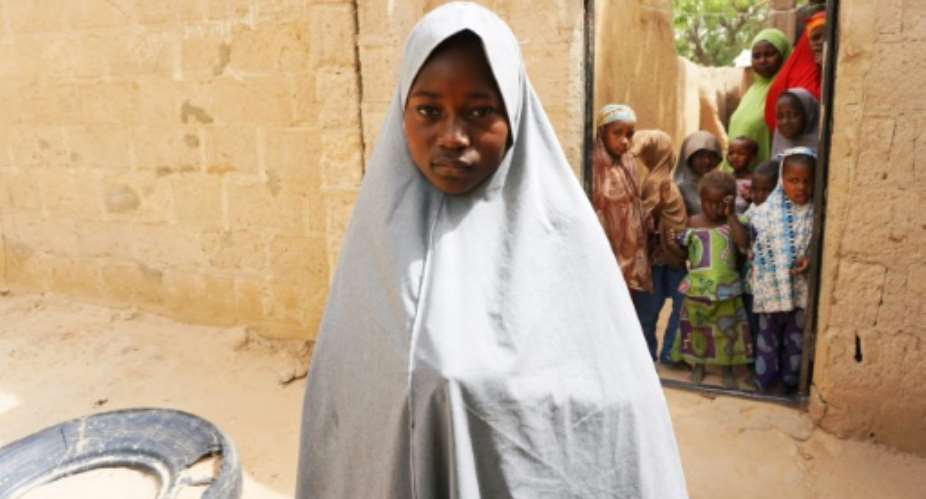 Hassana Mohammed, 13,  scaled a fence to escape.  By AMINU ABUBAKAR AFPFile
