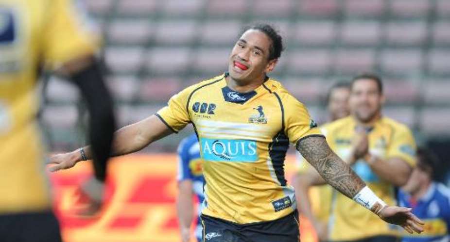 Australian winger Joe Tomane of the Brumbies celebrates after scoring during their Super XV qualifier match againt the Western Stormers at Newlands on June 20, 2015 in Cape Town, South Africa.  By Luigi Bennett AFP