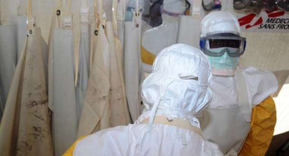 Members of Doctors Without Borders wear protective gear at the isolation ward of the Donka Hospital in Conakry, where people infected with the Ebola virus are being treated, June 28, 2014.  By Cellou Binani AFPFile