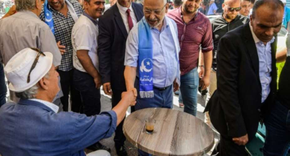 Head of the Ennahdha party Rached Ghannouchi campaigned in the Bab Jdid district of Tunisia's capital Tunis.  By FETHI BELAID AFP