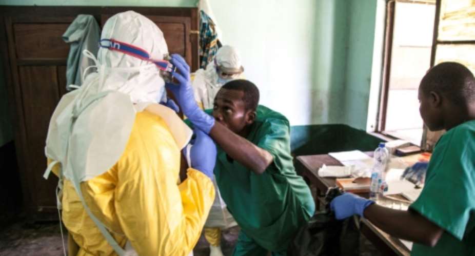 Health workers don protective gear before examining suspected Ebola patients at Bikoro hospital in DR Congo's Equateur province.  By MARK NAFTALIN UNICEFAFPFile