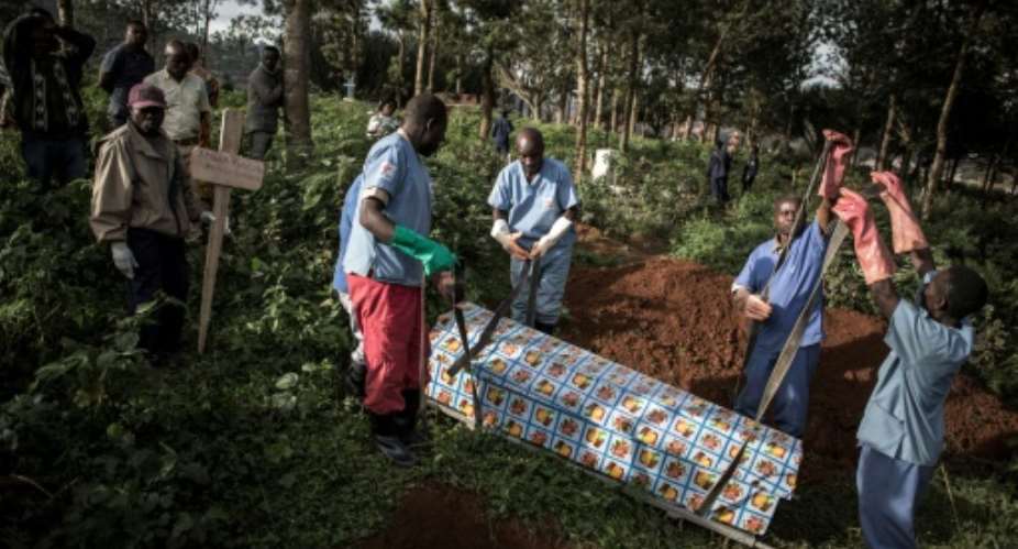 Health workers prepare to bury an Ebola victim in Butembo. More than 2,000 cases have been recorded since the disease broke out in eastern DR Congo 10 months ago.  By JOHN WESSELS AFP