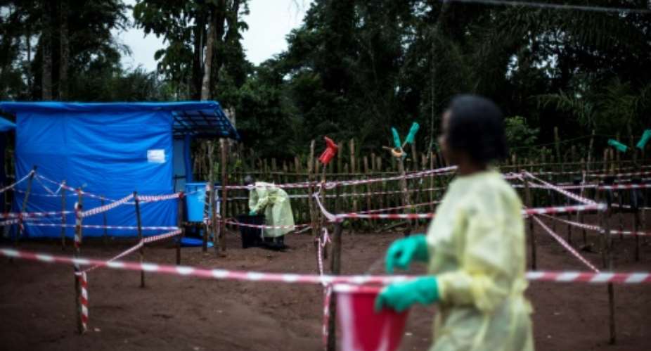 Health workers work at an Ebola quarantine unit on June 13, 2017 in Muma, after a one case of Ebola was confirmed in their village.  By JOHN WESSELS AFPFile