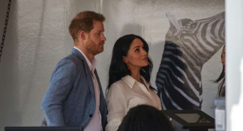Helping hand: Prince Harry and his wife Meghan, the Duchess of Sussex, at a youth employment hub in Johannesburg.  By Michele Spatari AFP