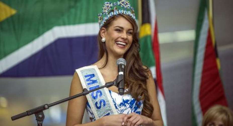 Rolene Strauss, the newly crowned Miss World 2014, gives a speech upon her arrival at OR Tambo Airport in Johannesburg on December 20, 2014.  By Mujahid Safodien AFP