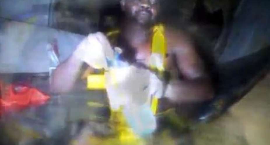 This picture released by DCN Diving Netherlands on December 4, 2013 shows Harrison Odjegba Okene opening a bottle of water after being rescued off Nigeria's coast in May, 2013.  By  DCN Diving NetherlandsAFP