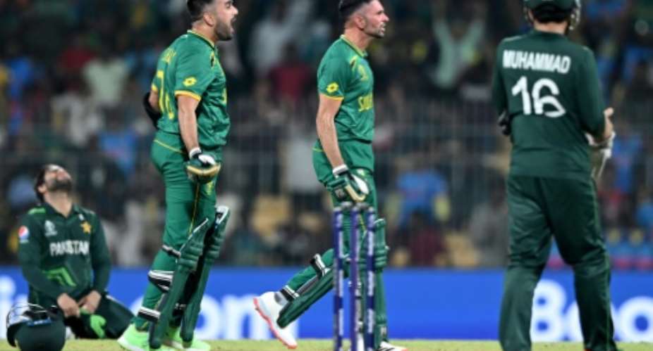 Highs and lows: South Africa's Tabraiz Shamsi and Keshav Maharaj celebrate as Pakistan players are crestfallen.  By R.Satish BABU AFP